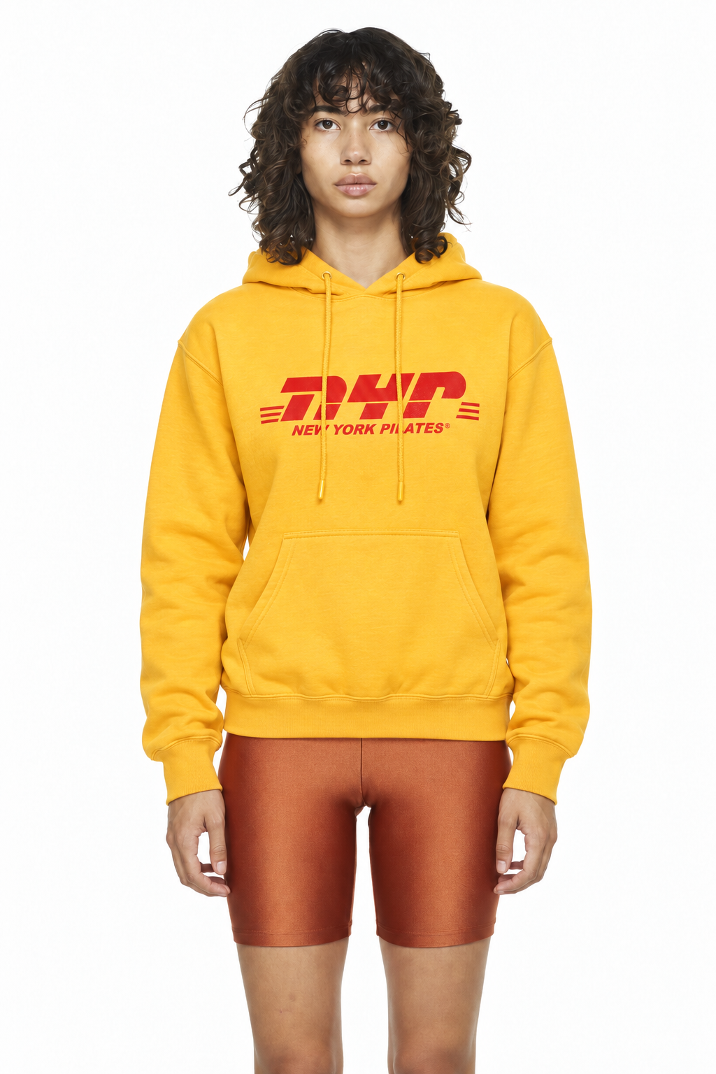 Model wearing the yellow New York Pilates Messenger Hoodie with red NYP logo — AI-generated product mockup